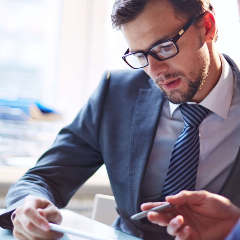 Two businessmen reviewing a sofware development contract.